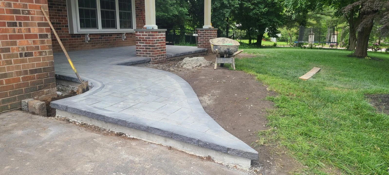 Curved concrete approach leading to a brick home